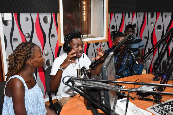 Four people in a radio studio